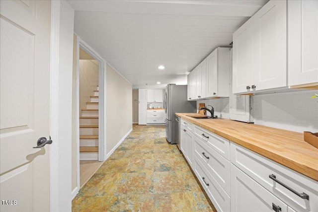 800 Camden Ave, Durham, NC 27701 - kitchen with wood counters, white cabinetry, light stone finish flooring, appliances with stainless steel finishes, and recessed lighting