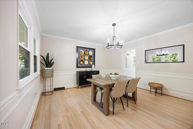 800 Camden Ave, Durham, NC 27701 - dining area with a chandelier, light wood finished floors, and crown molding