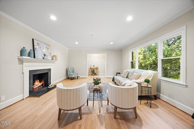 800 Camden Ave, Durham, NC 27701 - living room with light wood-style floors, baseboards, ornamental molding, recessed lighting, and a warm lit fireplace