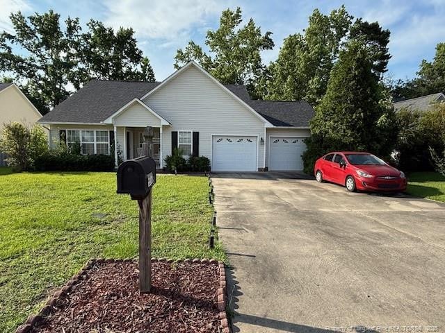 5516 Hall Glen Dr, Hope Mills, NC 28348 - single story home with a garage, driveway, and a front lawn
