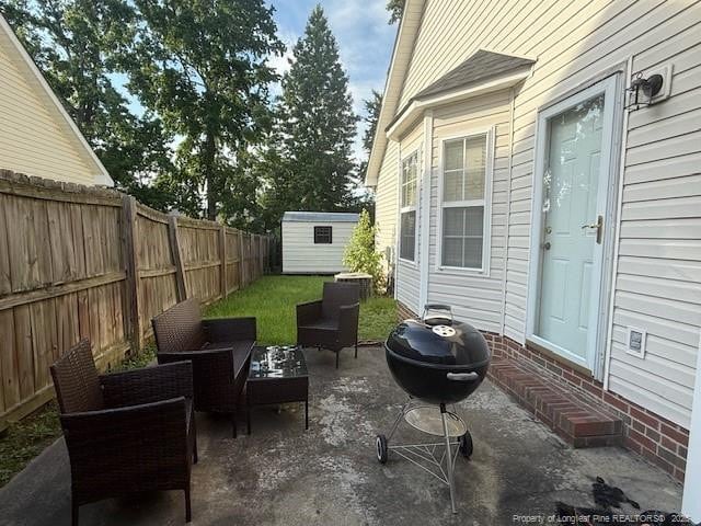 5516 Hall Glen Dr, Hope Mills, NC 28348 - fenced backyard with a patio and outdoor lounge area
