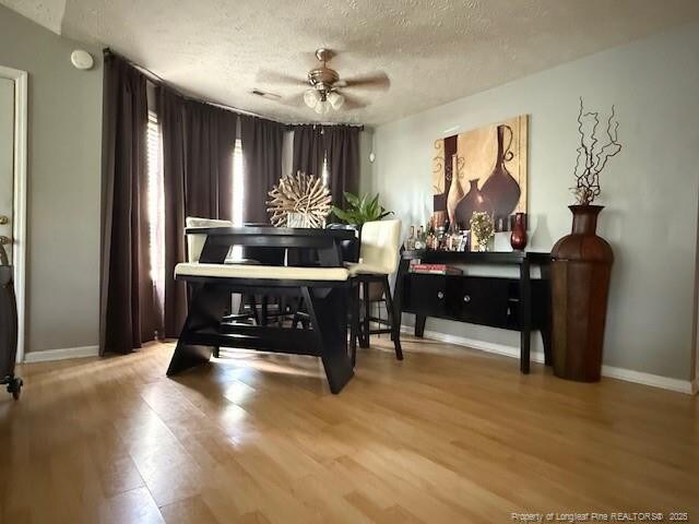 5516 Hall Glen Dr, Hope Mills, NC 28348 - living area with wood finished floors, a textured ceiling, and a ceiling fan