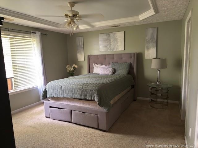 5516 Hall Glen Dr, Hope Mills, NC 28348 - carpeted bedroom featuring a tray ceiling, a ceiling fan, and ornamental molding
