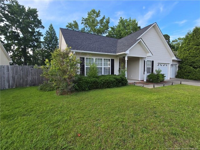 5516 Hall Glen Dr, Hope Mills, NC 28348 - view of front facade featuring driveway, roof with shingles, and a garage