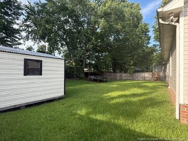 5516 Hall Glen Dr, Hope Mills, NC 28348 - view of yard with an outbuilding and a trampoline