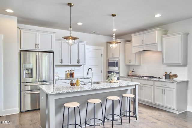 554 Beacon Ridge Blvd, Chapel Hill, NC 27516 - kitchen featuring stainless steel appliances, decorative backsplash, a kitchen bar, light wood finished floors, and recessed lighting