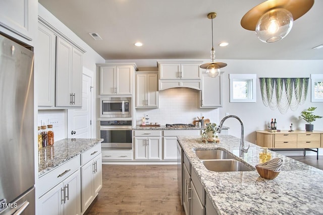 554 Beacon Ridge Blvd, Chapel Hill, NC 27516 - kitchen with stainless steel appliances, backsplash, hanging light fixtures, wood finished floors, and recessed lighting