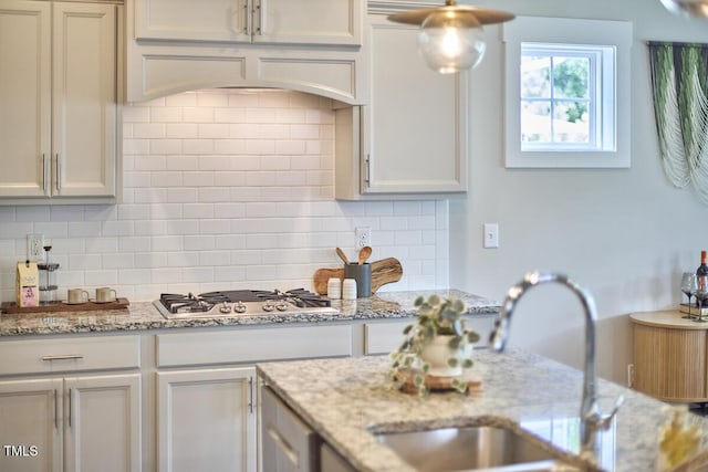 554 Beacon Ridge Blvd, Chapel Hill, NC 27516 - kitchen with stainless steel gas cooktop, backsplash, and light stone countertops