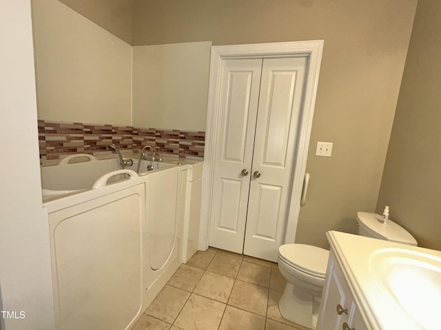 108 Calloway Rd, Rocky Mount, NC 27804 - bathroom with tile patterned floors, washer / clothes dryer, toilet, vanity, and a tub