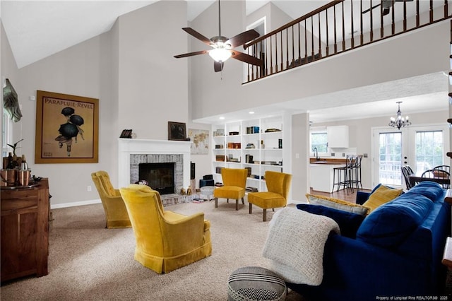 6745 Foxberry Rd, Fayetteville, NC 28314 - living room featuring a ceiling fan, a fireplace, a chandelier, carpet flooring, and a towering ceiling