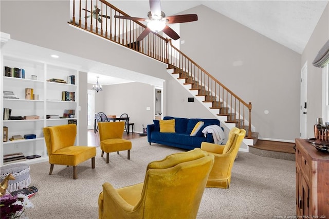 6745 Foxberry Rd, Fayetteville, NC 28314 - living area featuring high vaulted ceiling, stairway, carpet flooring, built in shelves, and ceiling fan
