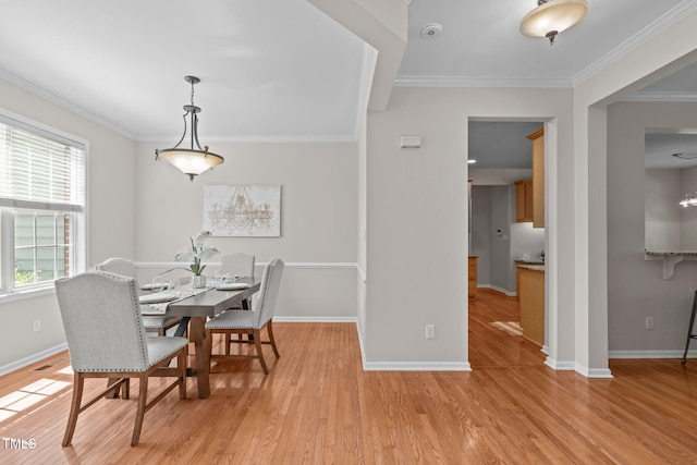 4804 Carmen Ln, Durham, NC 27707 - dining area with crown molding and light wood-style flooring