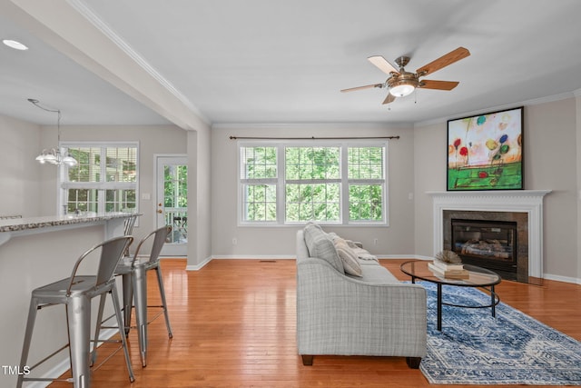 4804 Carmen Ln, Durham, NC 27707 - living area featuring light wood finished floors, crown molding, ceiling fan, and a glass covered fireplace
