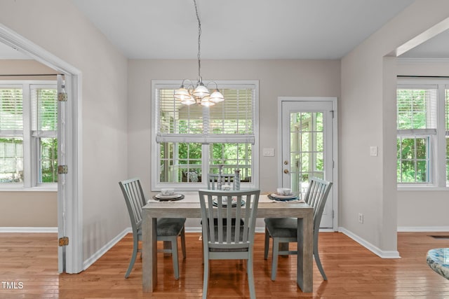 4804 Carmen Ln, Durham, NC 27707 - dining area with a chandelier and light wood-type flooring