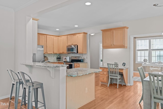 4804 Carmen Ln, Durham, NC 27707 - kitchen featuring stainless steel appliances, light brown cabinets, a peninsula, a kitchen breakfast bar, and ornamental molding