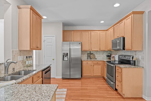 4804 Carmen Ln, Durham, NC 27707 - kitchen with appliances with stainless steel finishes, light brown cabinets, light wood finished floors, light stone counters, and recessed lighting