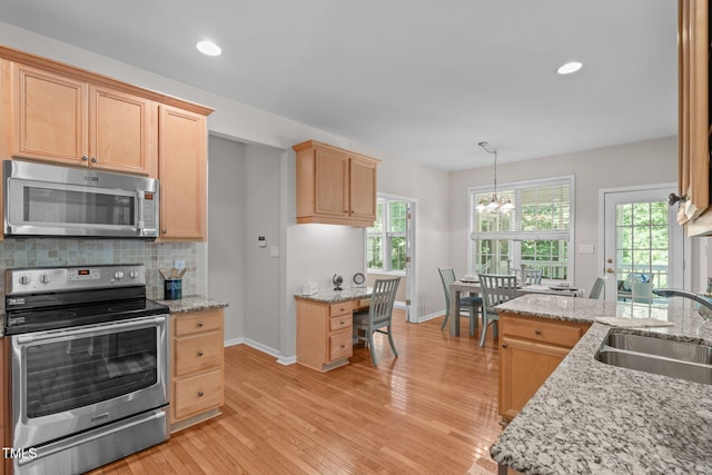 4804 Carmen Ln, Durham, NC 27707 - kitchen with stainless steel appliances, a chandelier, light brown cabinetry, light wood-type flooring, and light stone countertops