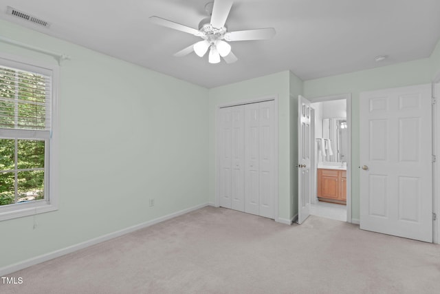 4804 Carmen Ln, Durham, NC 27707 - unfurnished bedroom with multiple windows, light colored carpet, a closet, and ceiling fan