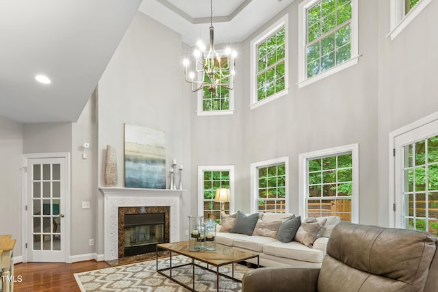 603 Edburton Ct, Hillsborough, NC 27278 - living room featuring a high ceiling, dark wood-style flooring, a chandelier, and a premium fireplace