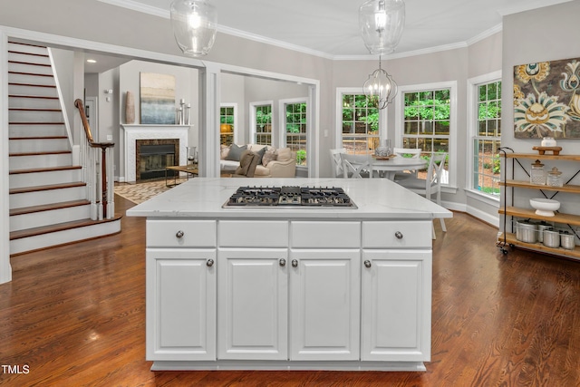 603 Edburton Ct, Hillsborough, NC 27278 - kitchen with stainless steel gas stovetop, white cabinets, ornamental molding, hanging light fixtures, and light stone countertops
