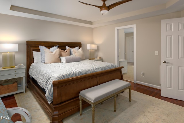 603 Edburton Ct, Hillsborough, NC 27278 - bedroom with wood finished floors, a tray ceiling, and a ceiling fan