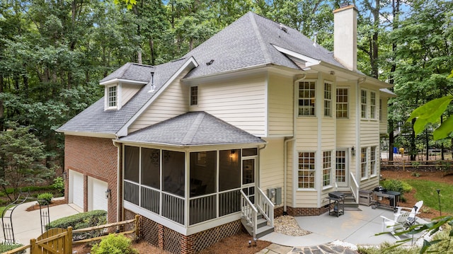 603 Edburton Ct, Hillsborough, NC 27278 - back of property featuring entry steps, a sunroom, a chimney, and roof with shingles