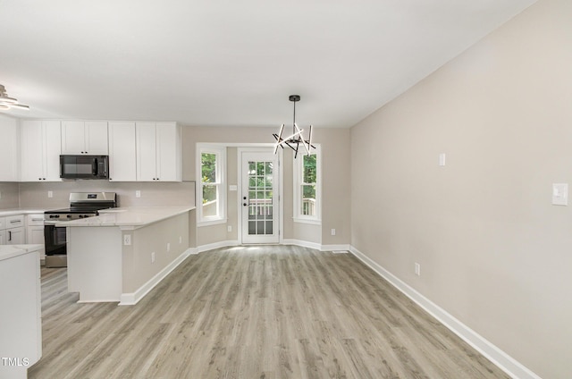 2324 Dahlgreen Rd, Raleigh, NC 27615 - kitchen featuring black microwave, stainless steel range, light wood-style floors, white cabinetry, and light countertops