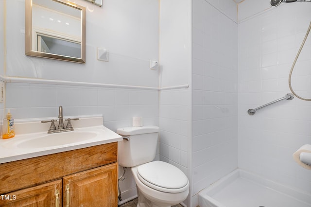 2817 Henslowe Dr, Raleigh, NC 27603 - full bathroom featuring a tile shower, vanity, tile walls, and wainscoting