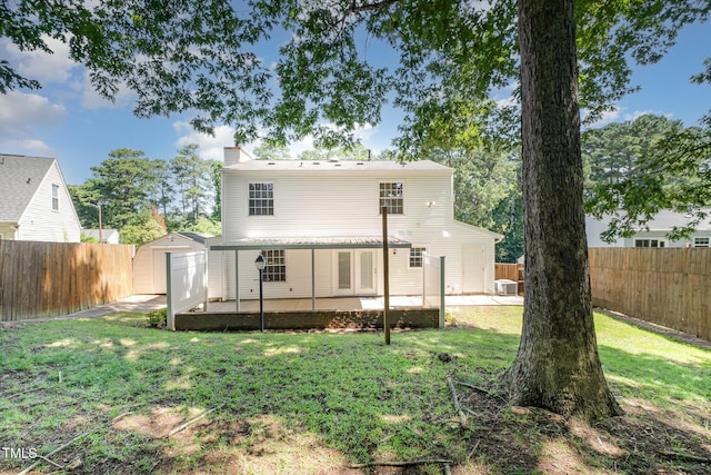 2817 Henslowe Dr, Raleigh, NC 27603 - back of property with a patio area, a storage unit, a chimney, and a fenced backyard