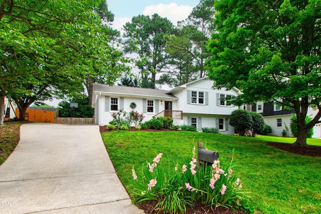 433 Rosehaven Dr, Raleigh, NC 27609 - split level home featuring concrete driveway and a chimney