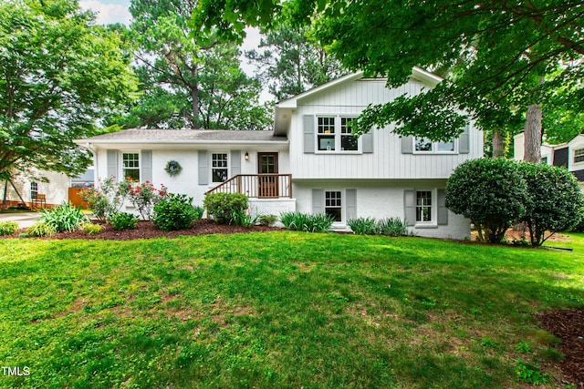 433 Rosehaven Dr, Raleigh, NC 27609 - tri-level home with brick siding, a front lawn, and board and batten siding