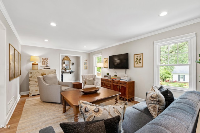 433 Rosehaven Dr, Raleigh, NC 27609 - living area featuring plenty of natural light, light wood-type flooring, recessed lighting, and crown molding