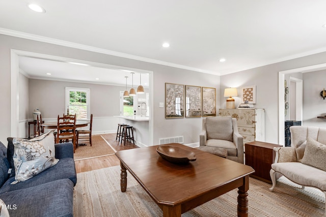 433 Rosehaven Dr, Raleigh, NC 27609 - living room featuring light wood-type flooring, recessed lighting, and ornamental molding