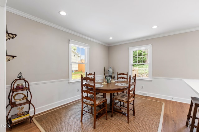 433 Rosehaven Dr, Raleigh, NC 27609 - dining area with light wood-style flooring, crown molding, and recessed lighting