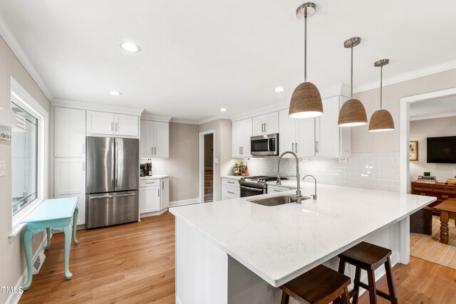 433 Rosehaven Dr, Raleigh, NC 27609 - kitchen with appliances with stainless steel finishes, ornamental molding, light wood-type flooring, a peninsula, and decorative backsplash