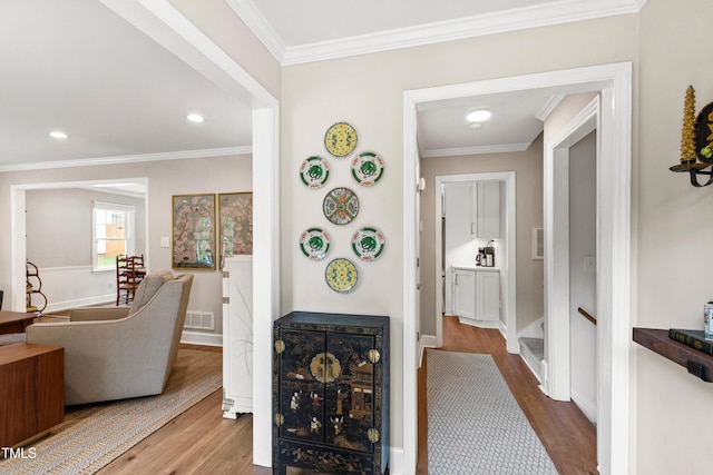 433 Rosehaven Dr, Raleigh, NC 27609 - hallway featuring wood finished floors, ornamental molding, and recessed lighting
