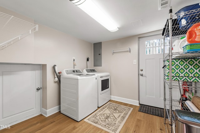 433 Rosehaven Dr, Raleigh, NC 27609 - laundry room featuring electric panel, light wood-type flooring, and washer and dryer