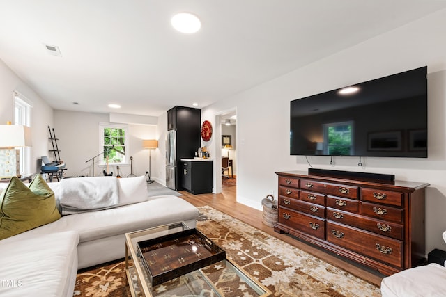 433 Rosehaven Dr, Raleigh, NC 27609 - living room with light wood finished floors and recessed lighting