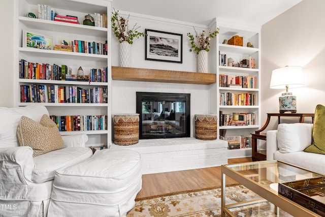 433 Rosehaven Dr, Raleigh, NC 27609 - sitting room with a brick fireplace and wood finished floors