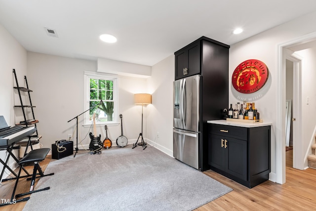 433 Rosehaven Dr, Raleigh, NC 27609 - workout area featuring light wood-style flooring, a bar, and recessed lighting