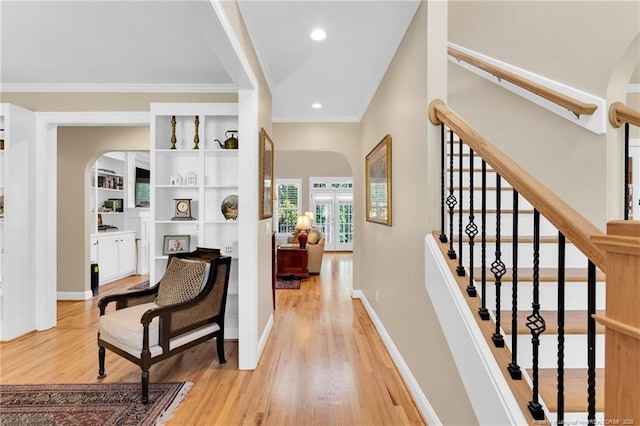 6558 Countryside Dr, Fayetteville, NC 28311 - corridor with light wood-type flooring, crown molding, arched walkways, recessed lighting, and stairway