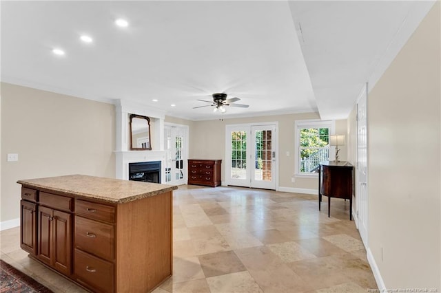 6558 Countryside Dr, Fayetteville, NC 28311 - kitchen featuring a fireplace, baseboards, ceiling fan, a kitchen island, and recessed lighting