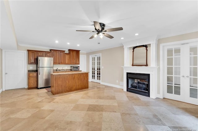 6558 Countryside Dr, Fayetteville, NC 28311 - kitchen with freestanding refrigerator, french doors, open floor plan, brown cabinetry, and ceiling fan