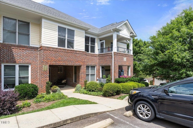 800 Savannah Ridge Rd Unit 109, Holly Springs, NC 27540 - view of front of home with brick siding, a balcony, and uncovered parking