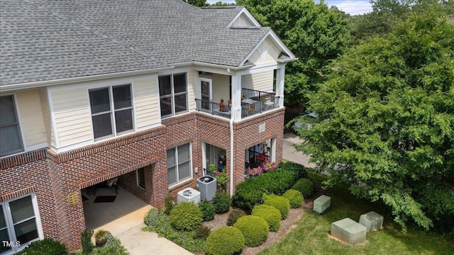 800 Savannah Ridge Rd Unit 109, Holly Springs, NC 27540 - view of side of home featuring a shingled roof, a balcony, and brick siding