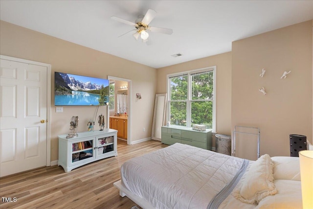 800 Savannah Ridge Rd Unit 109, Holly Springs, NC 27540 - bedroom featuring light wood finished floors, connected bathroom, and a ceiling fan