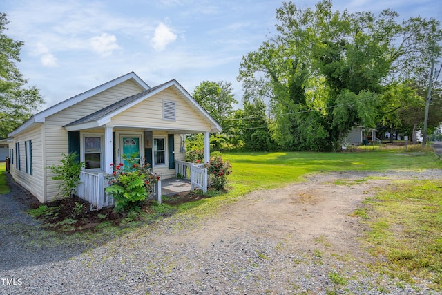 306 W Main St, Pine Level, NC 27568 - view of front facade with a porch and a front lawn
