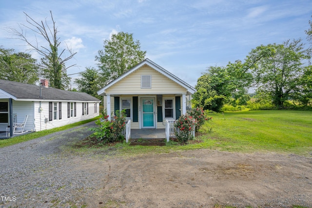 306 W Main St, Pine Level, NC 27568 - shotgun-style home with covered porch and a front yard