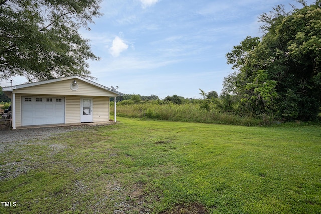 306 W Main St, Pine Level, NC 27568 - view of green lawn with an outdoor structure, a detached garage, and gravel driveway