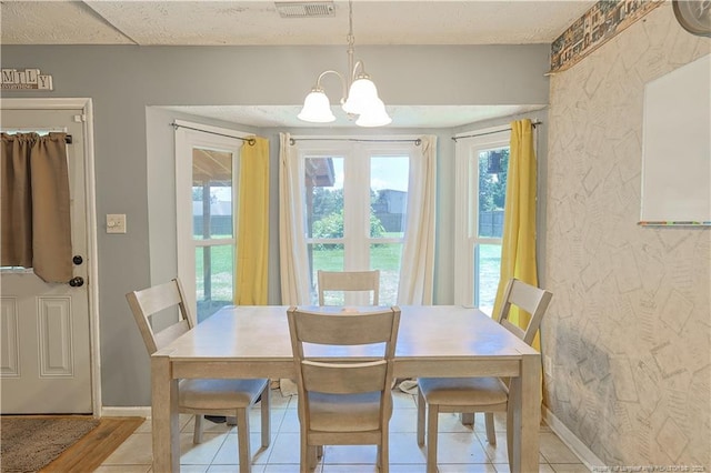 104 Blue Jay Ct, Fayetteville, NC 28306 - dining space with a chandelier, light tile patterned floors, and baseboards